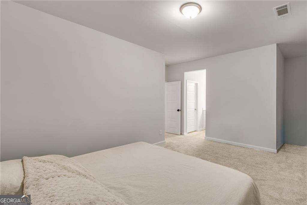 338 Ryston Way Grayson, GA 30017 - Photo 41 of 61 a bedroom with a bed and a night stand