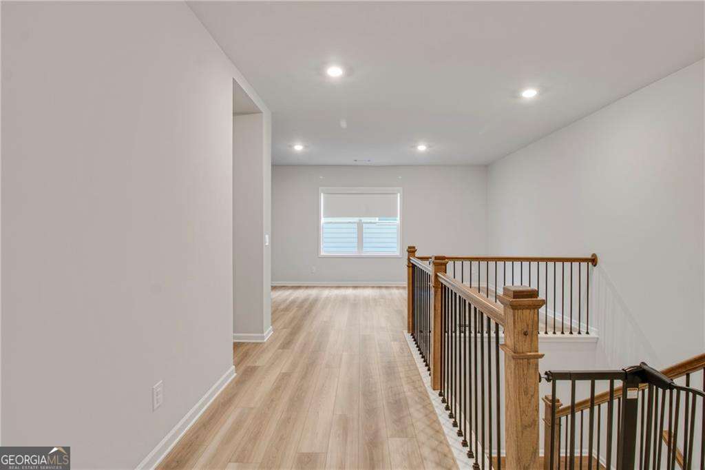 338 Ryston Way Grayson, GA 30017 - Photo 44 of 61 a view of a hallway with wooden floor and staircase