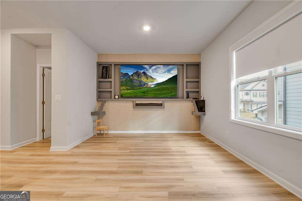 338 Ryston Way Grayson, GA 30017 - Photo 45 of 61 an empty room with wooden floor and windows