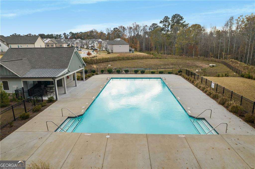 338 Ryston Way Grayson, GA 30017 - Photo 57 of 61 a view of a swimming pool with a lounge chair