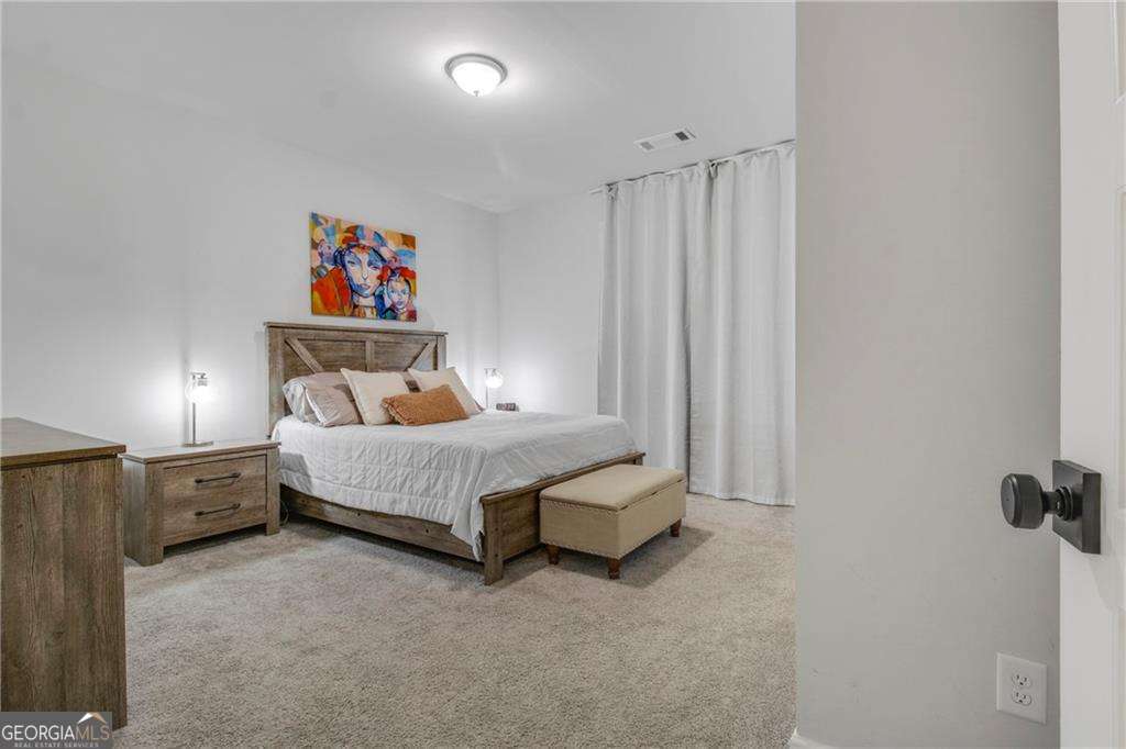 338 Ryston Way Grayson, GA 30017 - Photo 6 of 61 a bedroom with a bed and a painting on the wall