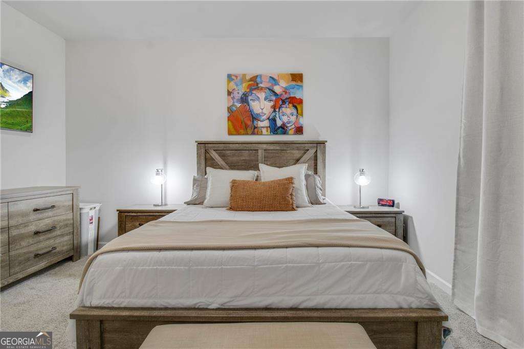 338 Ryston Way Grayson, GA 30017 - Photo 7 of 61 a bedroom with a bed and a painting on the wall