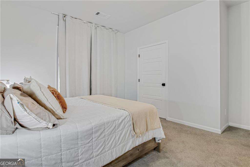 338 Ryston Way Grayson, GA 30017 - Photo 9 of 61 a bedroom with a bed and a window