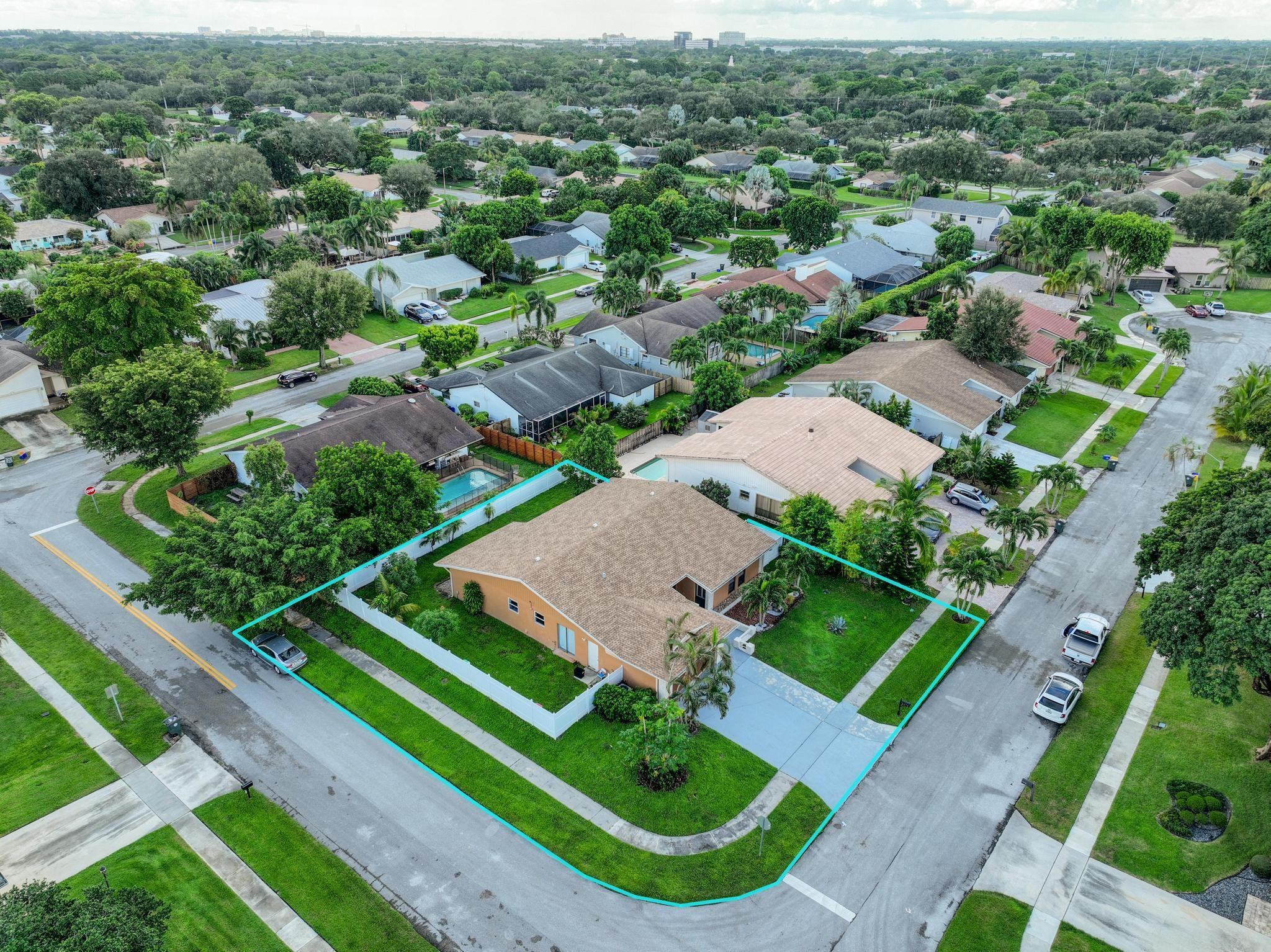 an aerial view of residential houses with outdoor space and street view