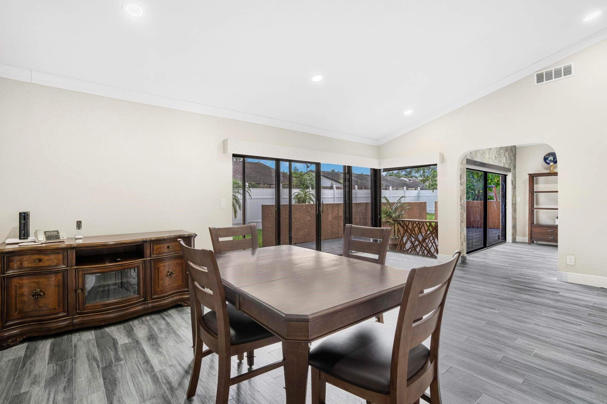 3374 Northwest 27th Terrace Boca Raton, FL 33434 - Photo 16 of 33 a view of a dining room with furniture and wooden floor