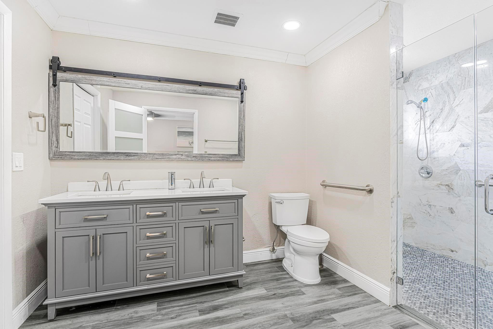 3374 Northwest 27th Terrace Boca Raton, FL 33434 - Photo 18 of 33 a bathroom with a toilet sink and a mirror