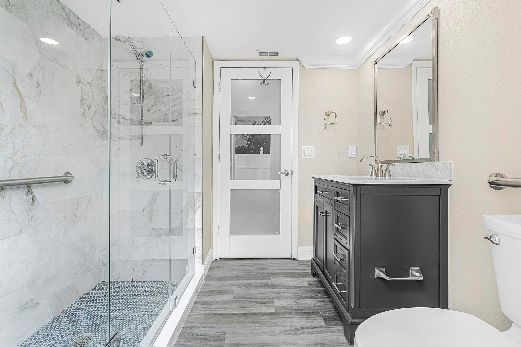 3374 Northwest 27th Terrace Boca Raton, FL 33434 - Photo 22 of 33 a bathroom with a shower toilet and sink