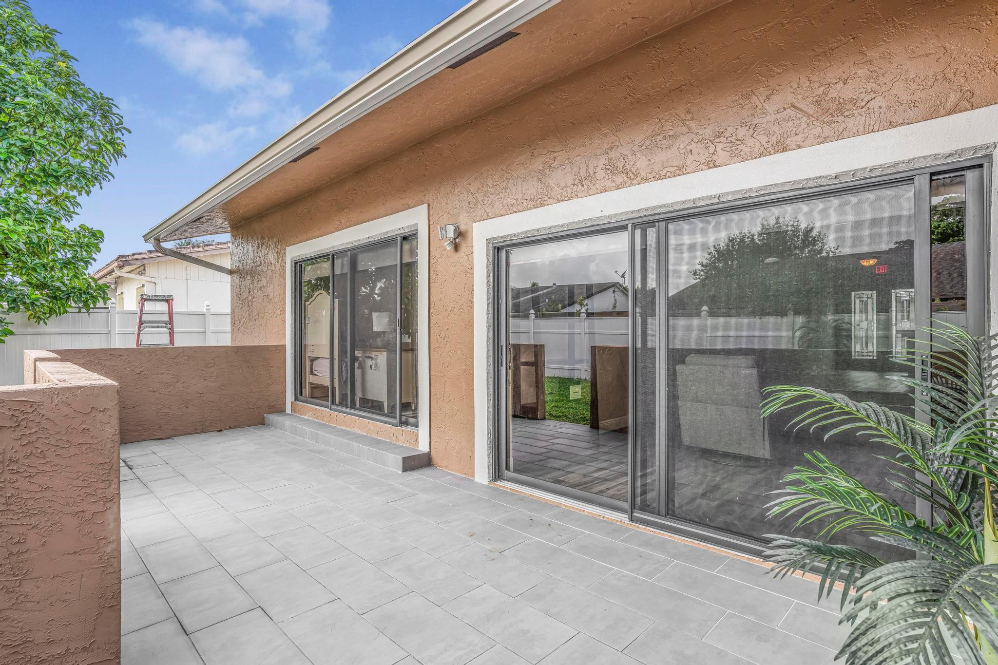 3374 Northwest 27th Terrace Boca Raton, FL 33434 - Photo 30 of 33 a porch with a glass door and glass door