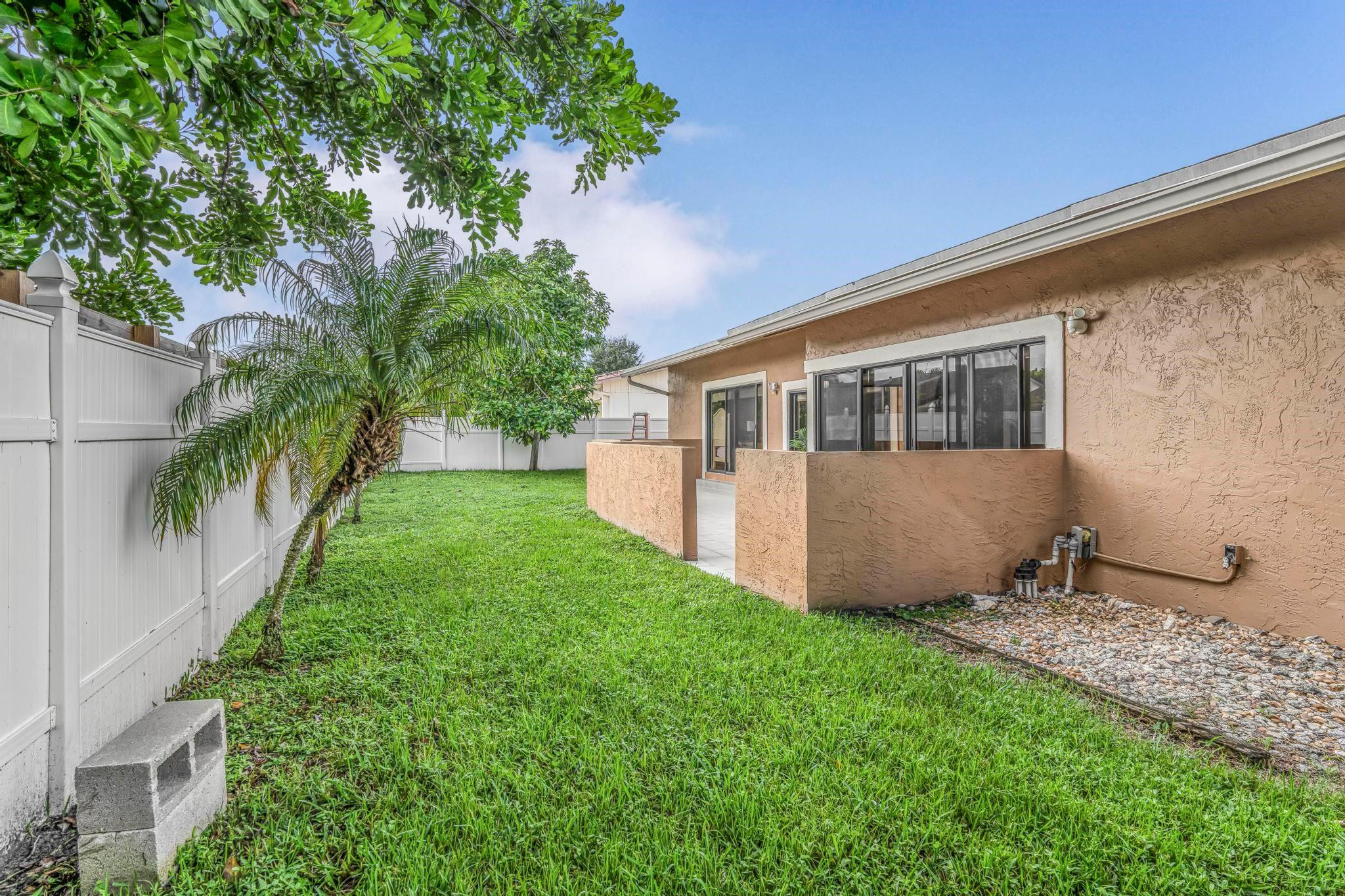3374 Northwest 27th Terrace Boca Raton, FL 33434 - Photo 32 of 33 a view of house with backyard