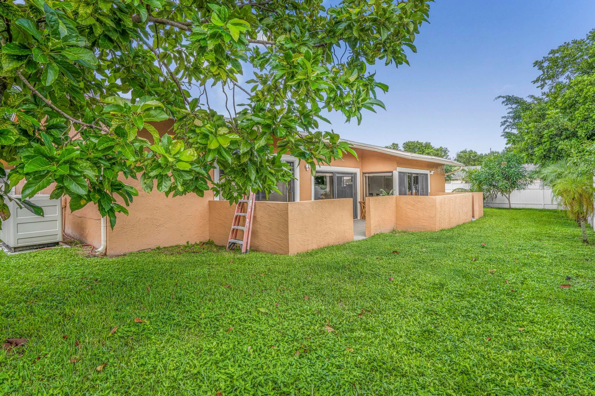 3374 Northwest 27th Terrace Boca Raton, FL 33434 - Photo 33 of 33 a view of a house with a yard and a patio