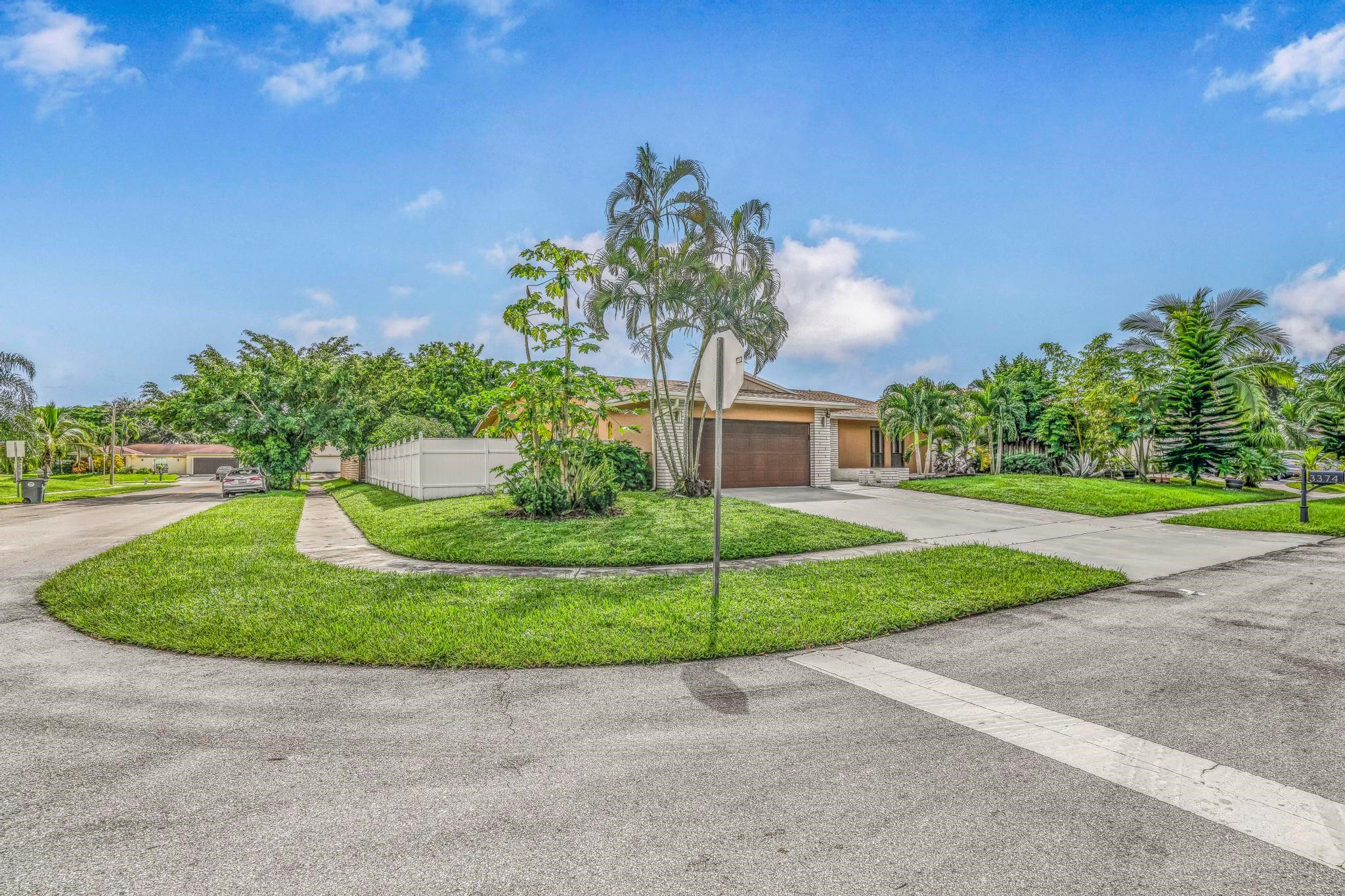 3374 Northwest 27th Terrace Boca Raton, FL 33434 - Photo 7 of 33 a front view of a house with garden