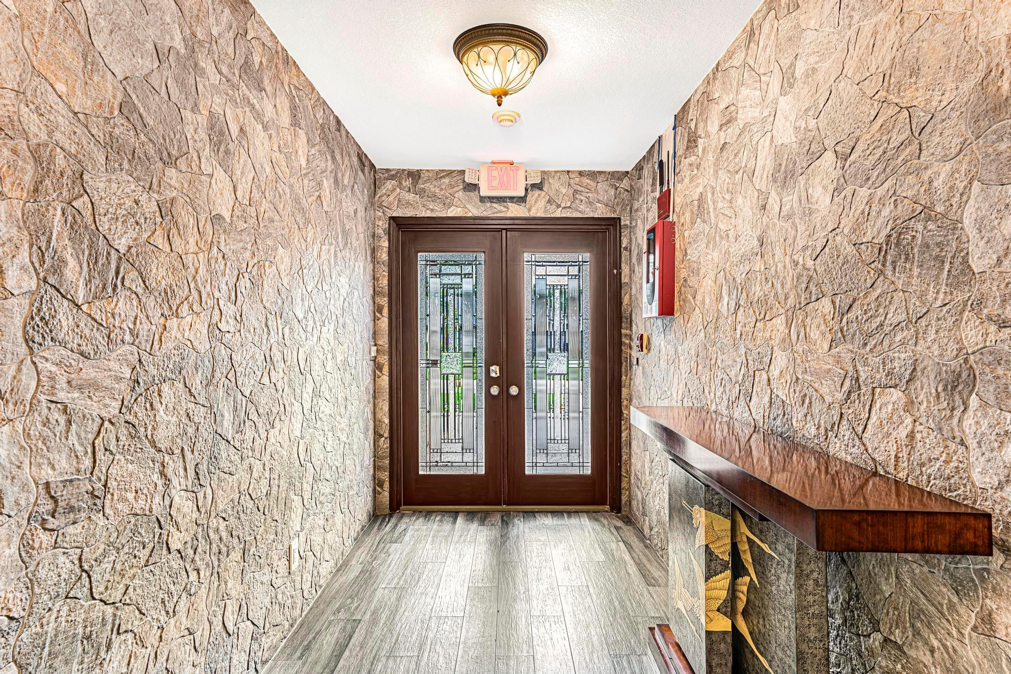 3374 Northwest 27th Terrace Boca Raton, FL 33434 - Photo 9 of 33 a view of a room with wooden floor and chandelier