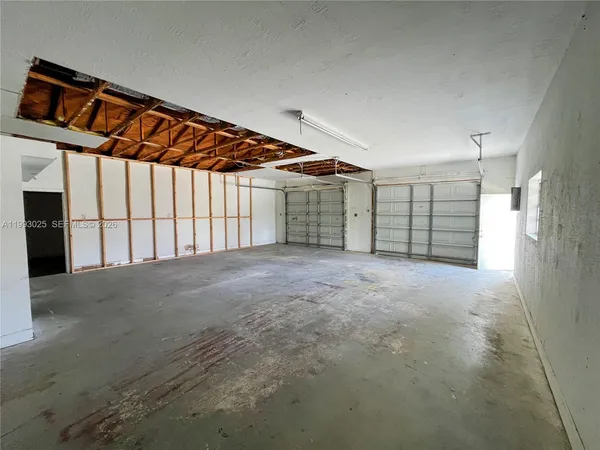 a view of an empty room with a garage