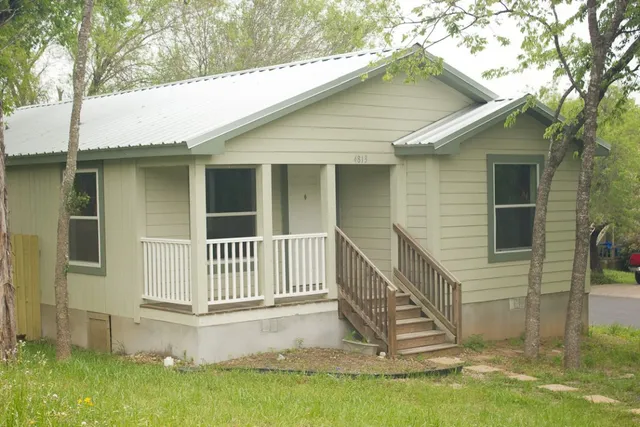 a front view of a house with a yard table and chairs