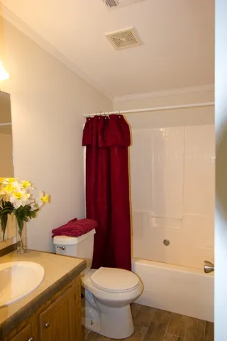 a kitchen with granite countertop white cabinets sink and stainless steel appliances