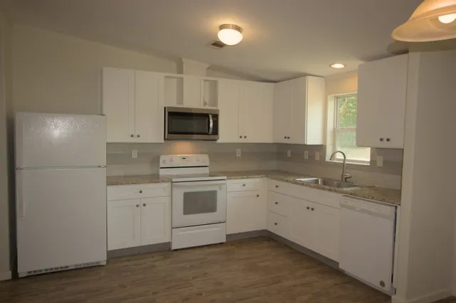 a kitchen with a sink cabinets and window