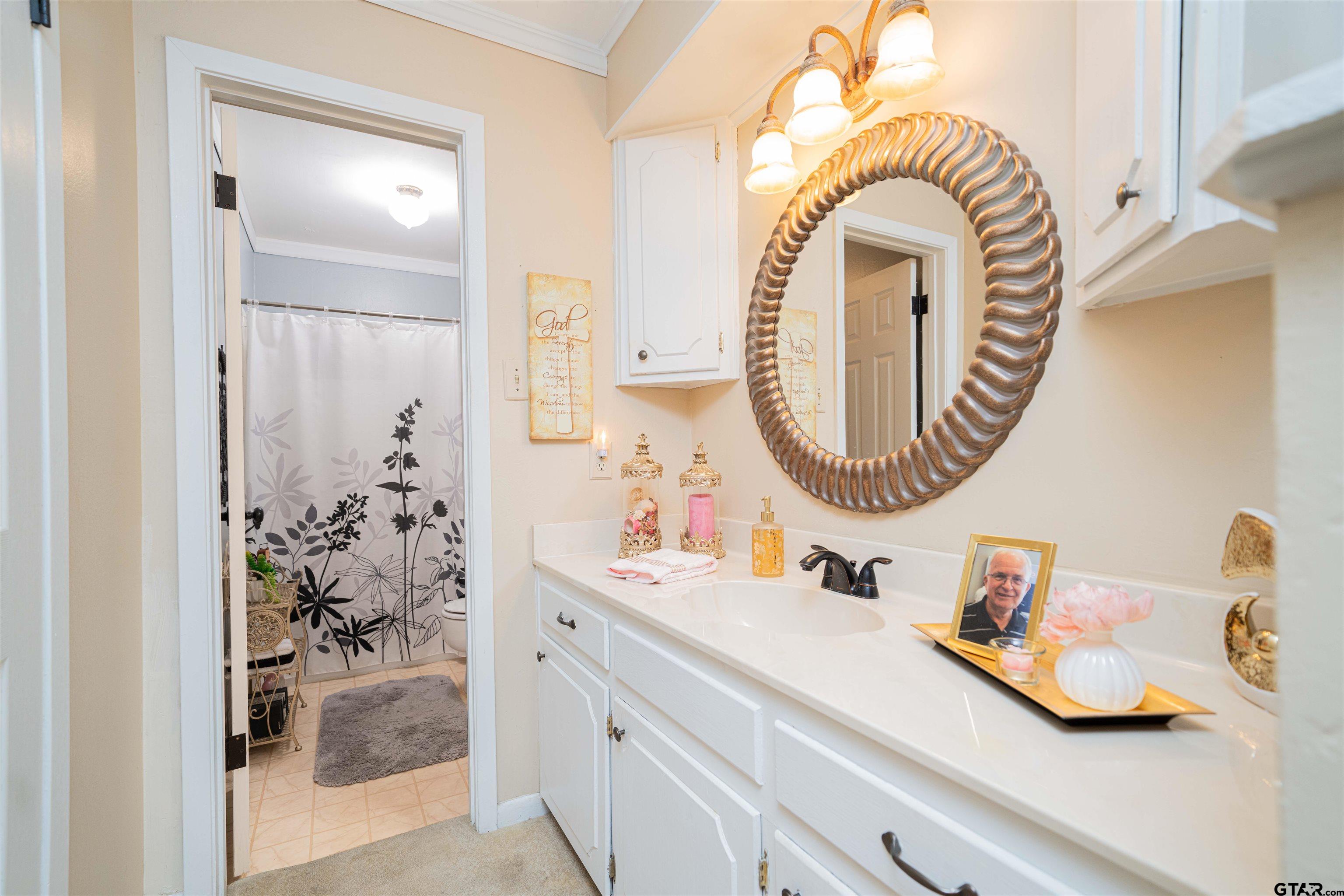 209 Cheryl Street Longview, TX 75604 - Photo 16 of 41 a bathroom with a sink a mirror and a shower