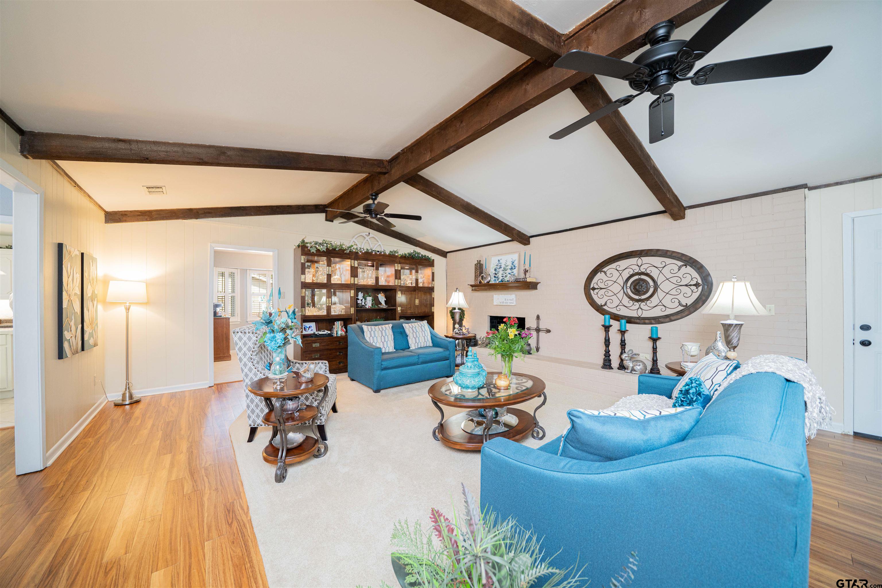 209 Cheryl Street Longview, TX 75604 - Photo 2 of 41 a living room with furniture a clock and white walls