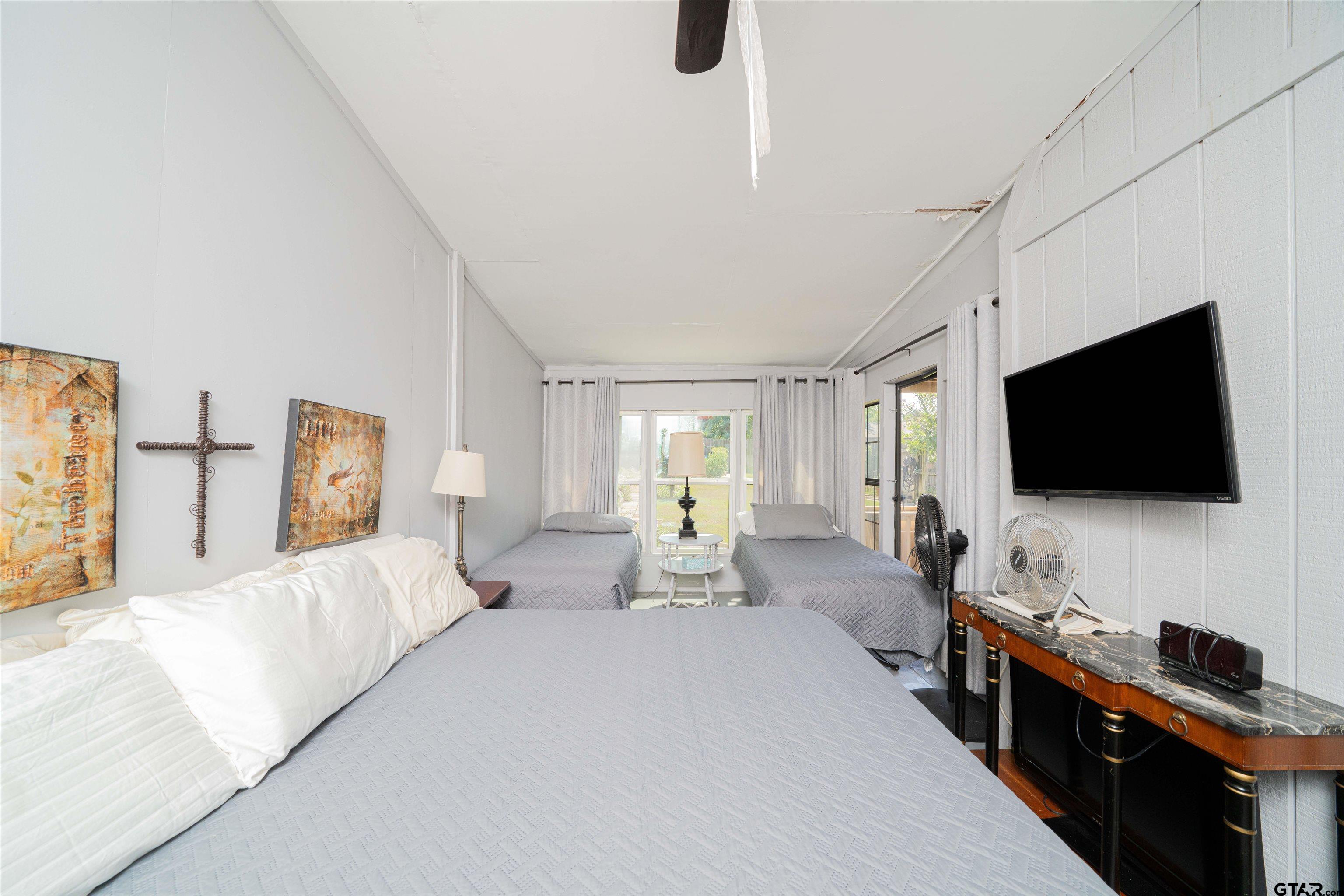 209 Cheryl Street Longview, TX 75604 - Photo 27 of 41 a living room with furniture and a flat screen tv