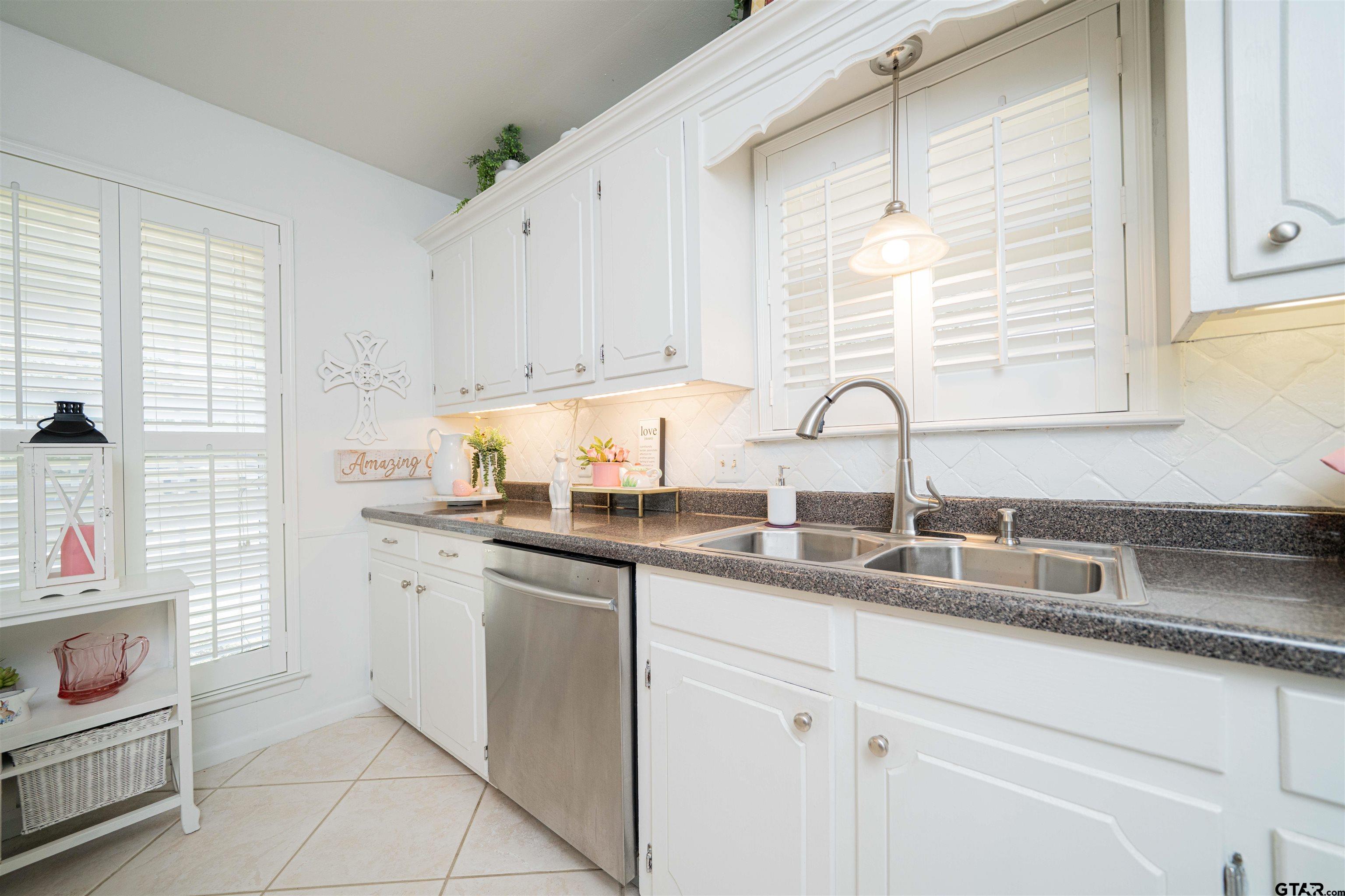 209 Cheryl Street Longview, TX 75604 - Photo 7 of 41 a kitchen with a sink cabinets and window