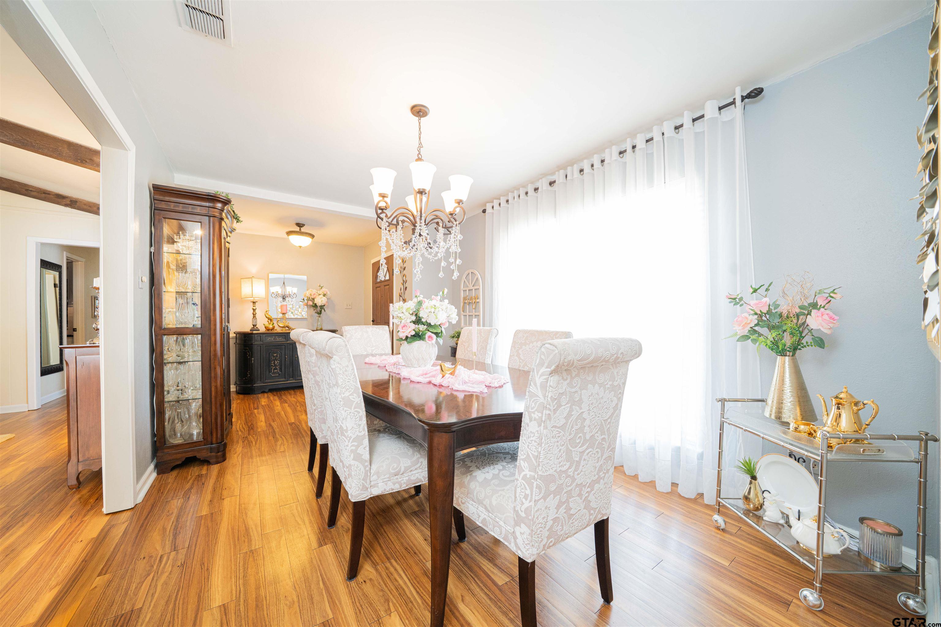 209 Cheryl Street Longview, TX 75604 - Photo 10 of 41 a view of a dining room with furniture and wooden floor