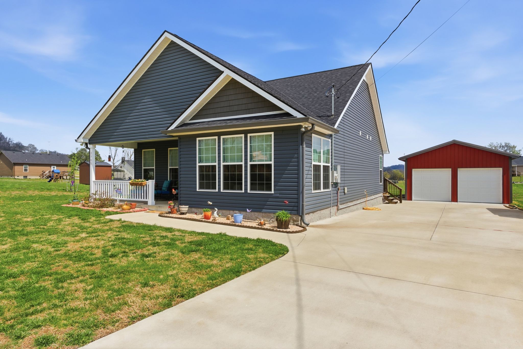 a front view of a house with a yard table and chairs