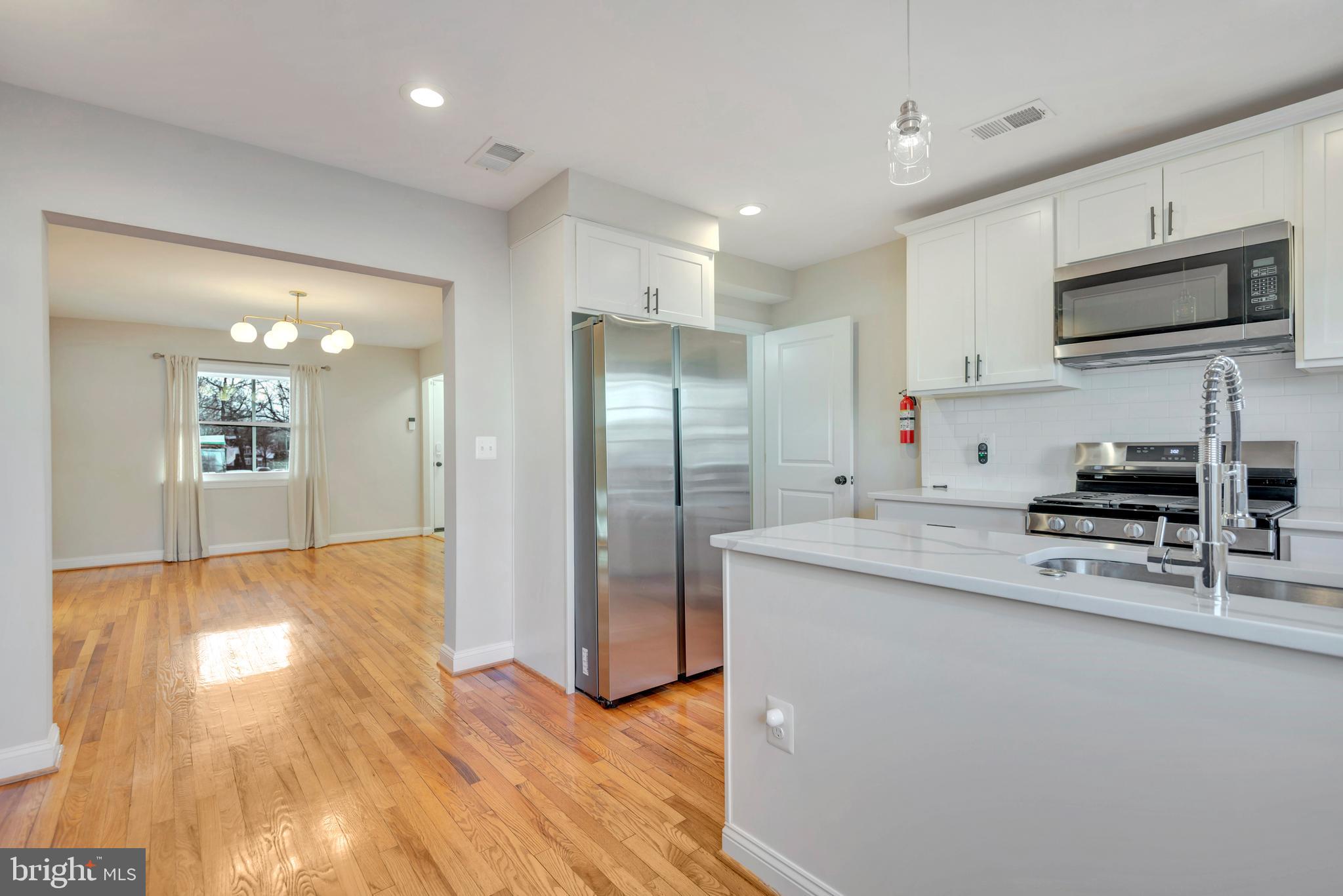 3428 Dix Street Northeast Washington, DC 20019 - Photo 11 of 21 a kitchen with stainless steel appliances a refrigerator microwave and sink