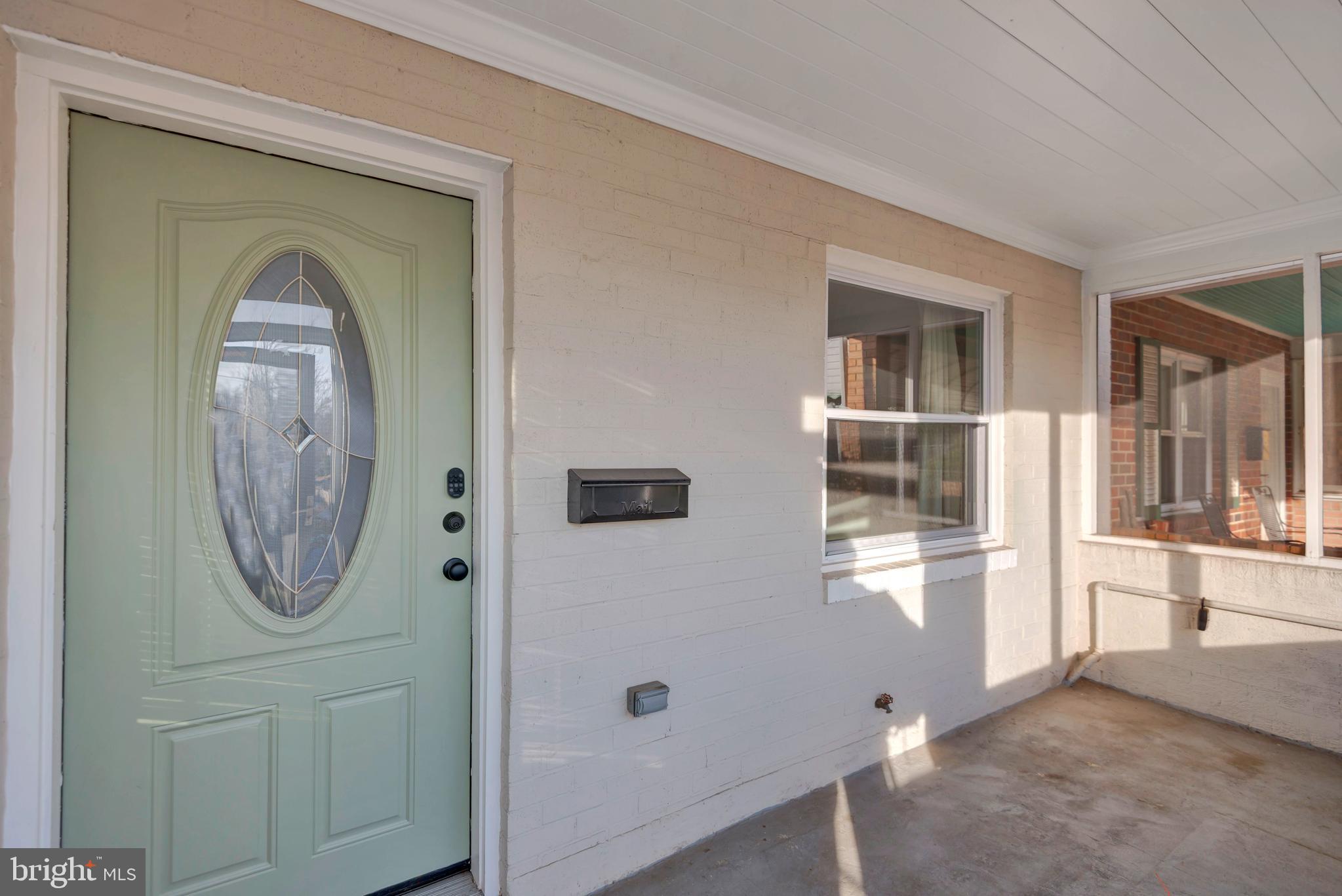 3428 Dix Street Northeast Washington, DC 20019 - Photo 3 of 21 an entryway with wooden floor mirror and windows