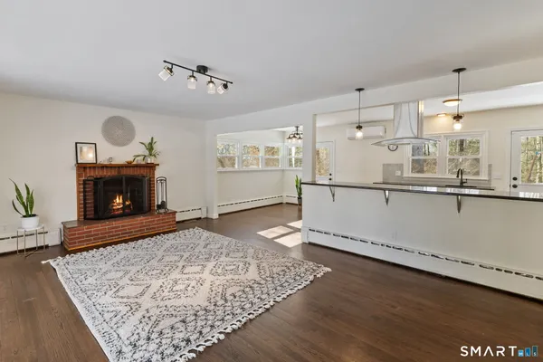 a living room with hard wood floors and a fireplace