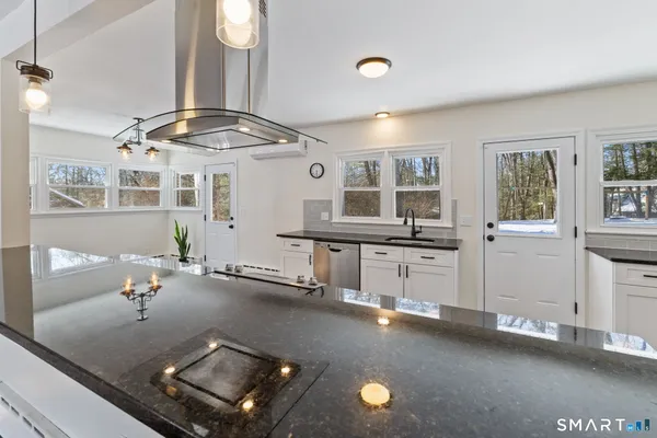 wooden floor with kitchen view and living room