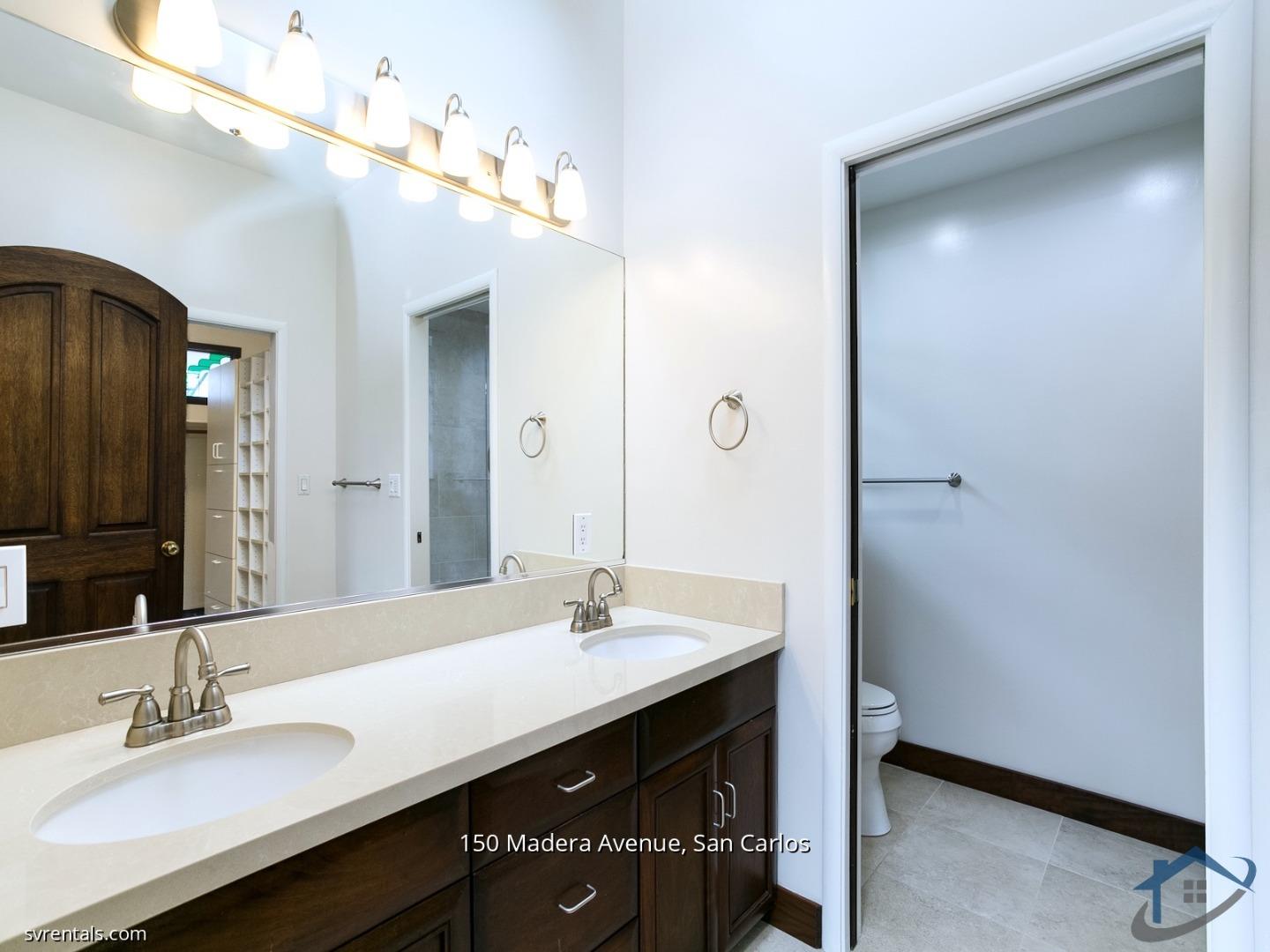 150 Madera Avenue San Carlos, CA 94070 - Photo 19 of 23 a bathroom with a double vanity sink a mirror and a shower