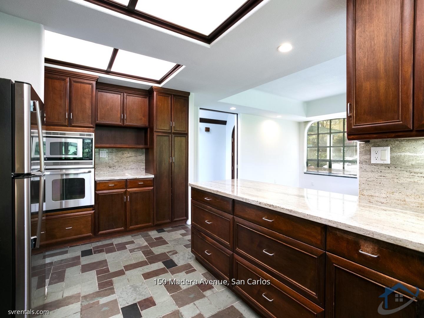 150 Madera Avenue San Carlos, CA 94070 - Photo 8 of 23 a kitchen with stainless steel appliances granite countertop a refrigerator and a sink