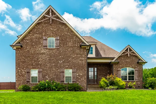 a front view of a house with a yard
