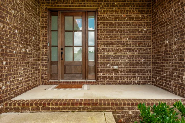 a view of a patio with couches chairs and wooden floor