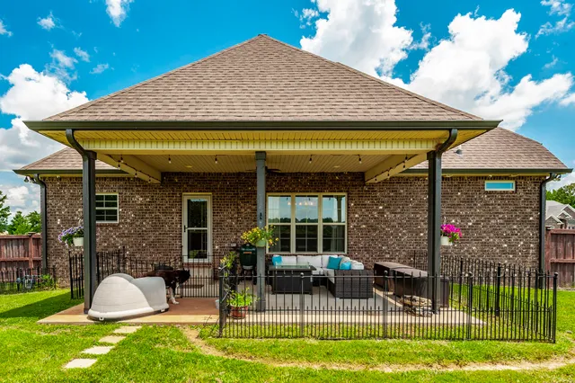 a living room with furniture a ceiling fan and a rug