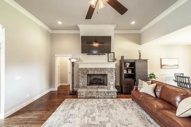 a living room with stainless steel appliances furniture a dining table and chairs