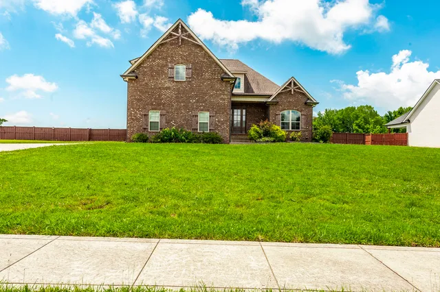 a front view of a house with a yard