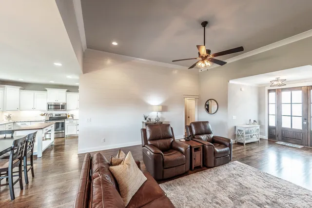 a kitchen with kitchen island granite countertop a sink a counter space appliances and cabinets
