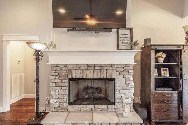 a bathroom with a granite countertop sink and a toilet