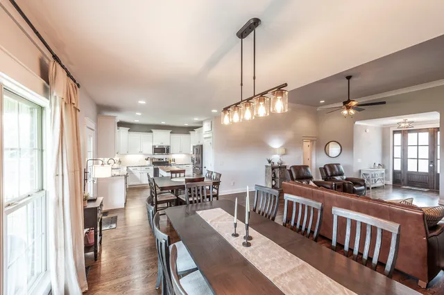 a bathroom with a granite countertop sink mirror and a shower
