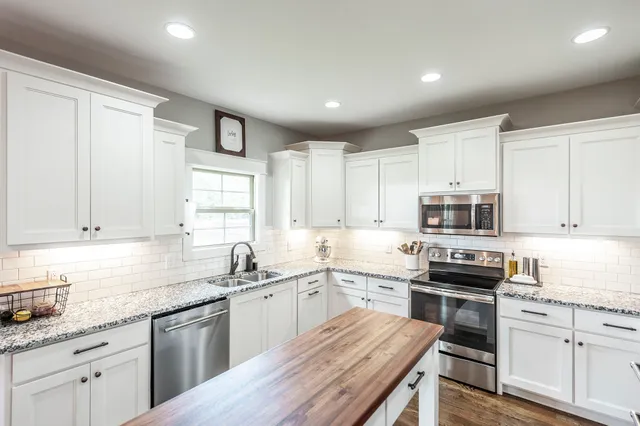 a living room with furniture a ceiling fan and a flat screen tv