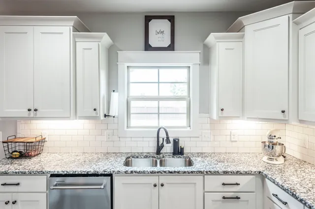 a living room with furniture a flat screen tv and a window