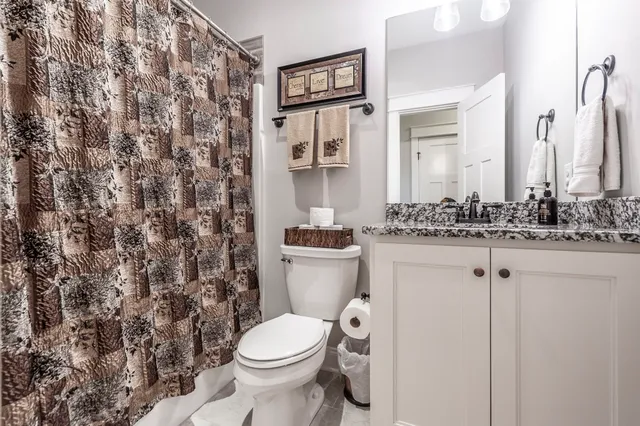 a hallway with white cabinets and wooden floor