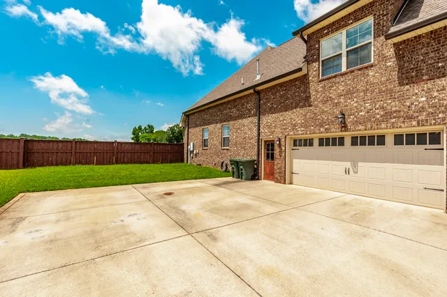 a view of a brick house with many windows