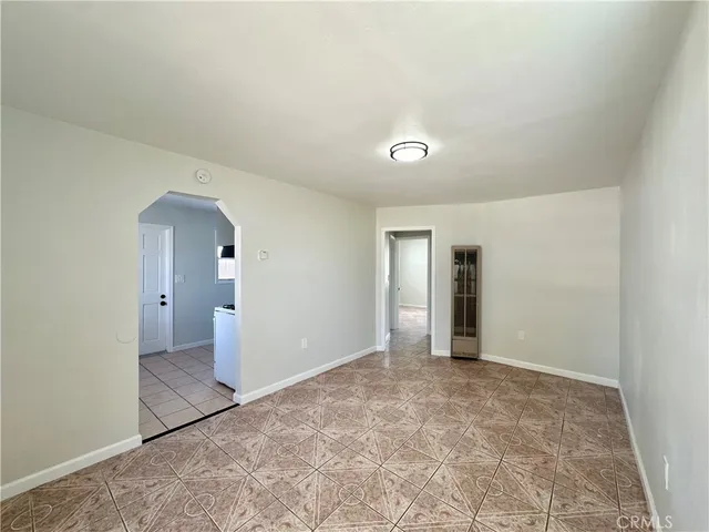 an empty room with closet and mirror