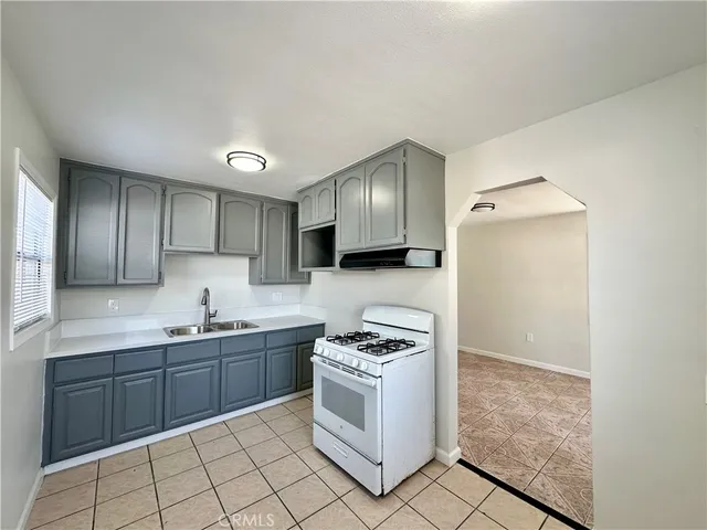 a kitchen with stainless steel appliances a refrigerator sink and cabinets