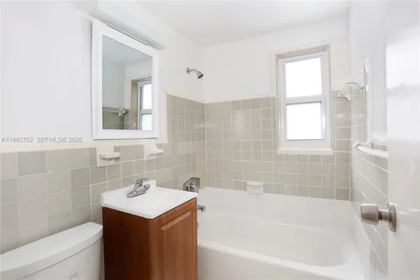 a bathroom with a sink toilet and bathtub