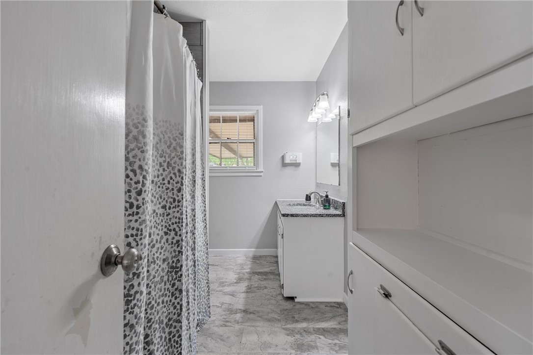 4701 Edmond Avenue Waco, TX 76710 - Photo 15 of 26 a bathroom with a sink and a mirror