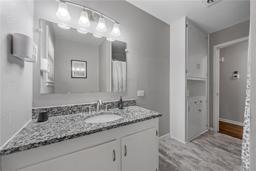 4701 Edmond Avenue Waco, TX 76710 - Photo 16 of 26 a bathroom with a sink and a mirror