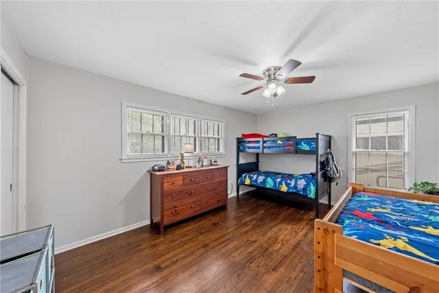 a bedroom with furniture and a wooden floor